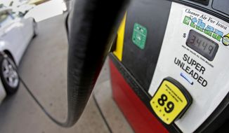In this July 26, 2013, file photo, a motorist fills up with gasoline containing ethanol in Des Moines. President Biden announced Tuesday that he would allow higher-ethanol gasoline blends to be sold this summer in his latest bid to curb high gasoline prices that have voters fuming. (AP Photo/Charlie Riedel, File)