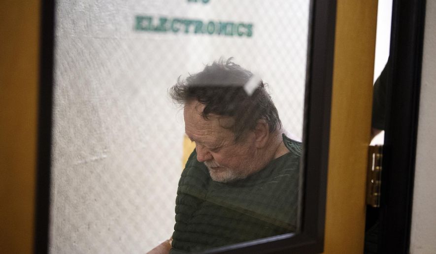 Robert E. Breck is wheeled into a courtroom for his initial appearance in Clark County Superior Court, Friday morning, Oct. 4, 2019, in Vancouver, Wash. The Vancouver Police Department says Breck fatally shot a man and shot and wounded two women the day before. (Amando Cowan/The Columbian via AP)