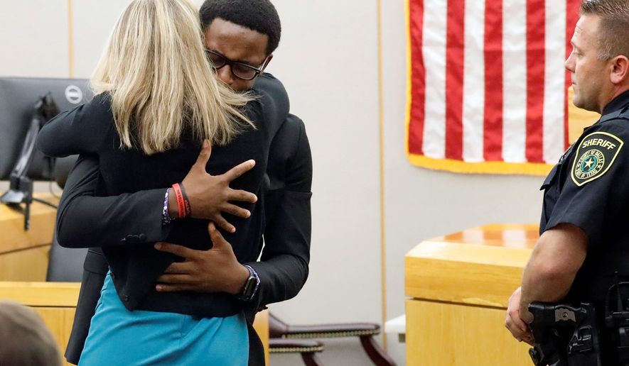 Brandt Jean hugs former Dallas Police Officer Amber Guyger. (Associated Press)