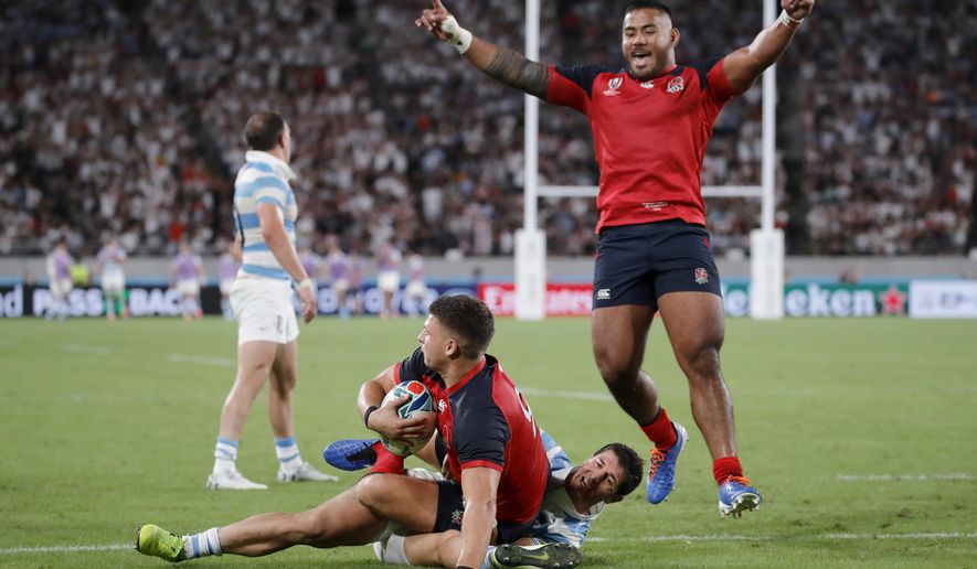CORRECTS NAME: Manu Tuilagi, right, celebrates after teammate Ben Youngs, left, after he scored a try against Argentina during the Rugby World Cup Pool C game at Tokyo Stadium in Tokyo, Japan, Saturday, Oct. 5, 2019. (AP Photo/Christophe Ena)