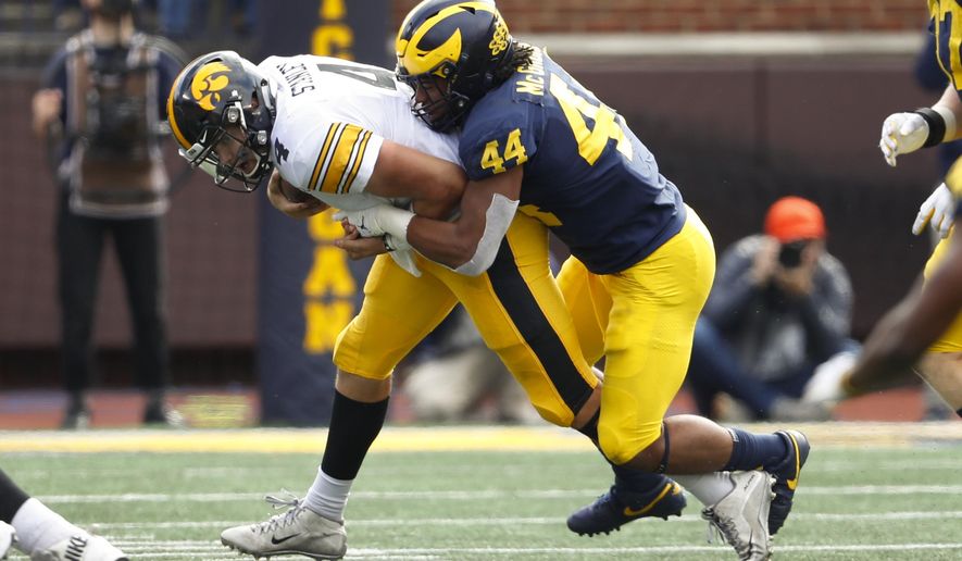 Michigan linebacker Cameron McGrone (44) sacks Iowa quarterback Nate Stanley (4) during the second half of an NCAA college football game in Ann Arbor, Mich., Saturday, Oct. 5, 2019. (AP Photo/Paul Sancya)