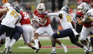 Wisconsin running back Jonathan Taylor (23) runs against Kent State cornerback Keith Sherald Jr. (15) during the first half of an NCAA college football game Saturday, Oct. 5, 2019, in Madison, Wis. (AP Photo/Andy Manis)