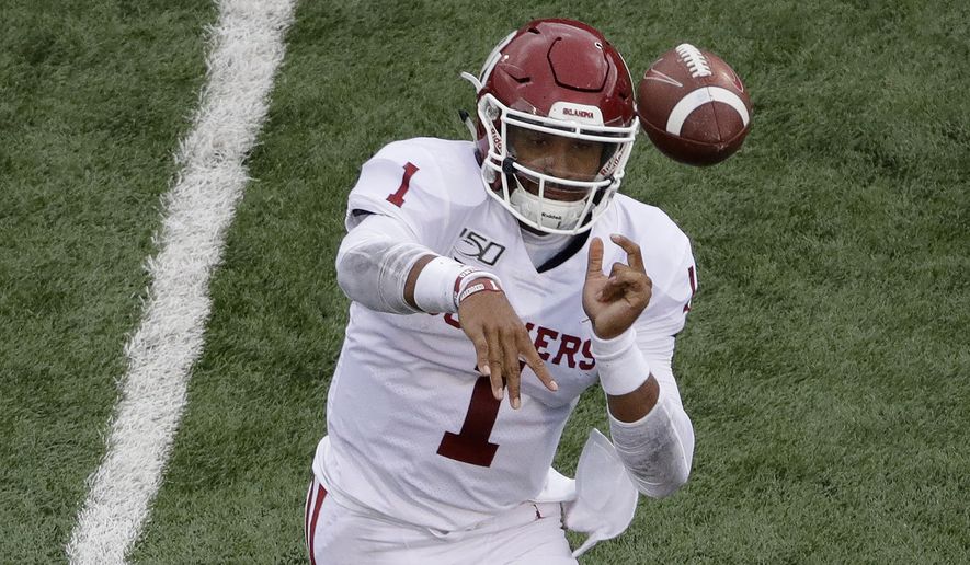 Oklahoma quarterback Jalen Hurts (1) throws a pass during the first half of an NCAA college football game against Kansas, Saturday, Oct. 5, 2019, in Lawrence, Kan. (AP Photo/Charlie Riedel)