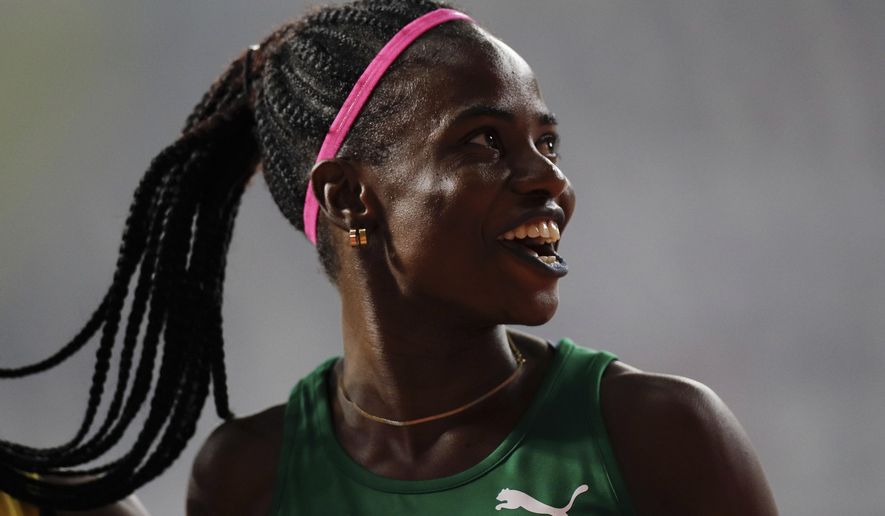 Tobi Amusan of Nigeria smiles after finishing a women&#39;s 100 meter hurdles heat at the World Athletics Championships in Doha, Qatar, Saturday, Oct. 5, 2019. (AP Photo/Petr David Josek)