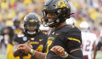 Missouri quarterback Kelly Bryant celebrates his touchdown with teammates during the first half of an NCAA college football game against Troy Saturday, Oct. 5, 2019, in Columbia, Mo. (AP Photo/L.G. Patterson)