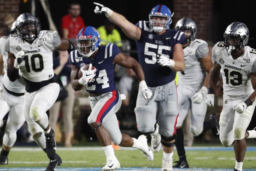 Mississippi offensive lineman Ben Brown (55) gestures as Mississippi running back Snoop Conner (24) heads for an 84-yard touchdown run against Vanderbilt during the second half of an NCAA college football game in Oxford, Miss., Saturday, Oct. 5, 2019. Mississippi won 31-6. (AP Photo/Rogelio V. Solis)