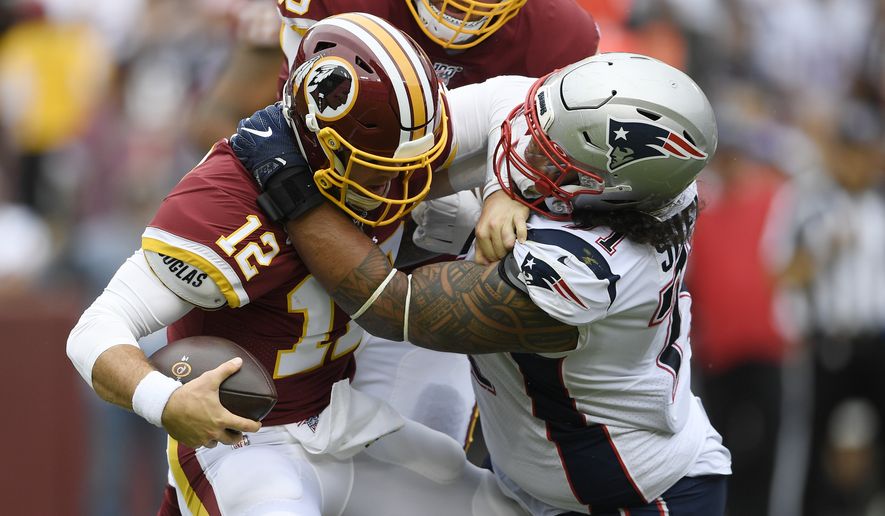 New England Patriots defensive tackle Danny Shelton (71) is sacked by Washington Redskins quarterback Colt McCoy (12) during the first half of an NFL football game, Sunday, Oct. 6, 2019, in Washington. (AP Photo/Nick Wass)