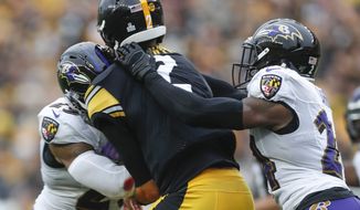 Pittsburgh Steelers quarterback Mason Rudolph (2) is hit by Baltimore Ravens free safety Earl Thomas (29), left, and cornerback Brandon Carr (24) during the second half of an NFL football game, Sunday, Oct. 6, 2019, in Pittsburgh. (AP Photo/Don Wright)