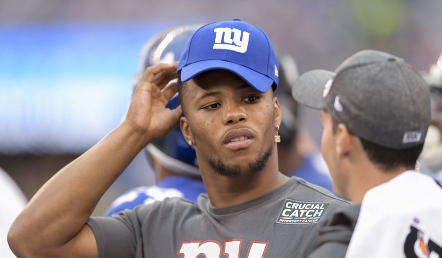 New York Giants running back Saquon Barkley (26) watches play from the sidelines against the Minnesota Vikings during an NFL football game, Sunday, Oct. 6, 2019, in East Rutherford, N.J. (AP Photo/Bill Kostroun) **FILE**