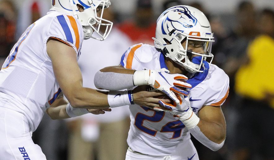 Boise State quarterback Chase Cord hands the ball to running back George Holani during the first half of an NCAA college football game against UNLV, Saturday, Oct. 5, 2019, in Las Vegas. (AP Photo/John Locher)