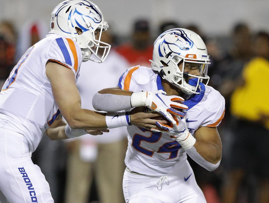 Boise State quarterback Chase Cord hands the ball to running back George Holani during the first half of an NCAA college football game against UNLV, Saturday, Oct. 5, 2019, in Las Vegas. (AP Photo/John Locher)