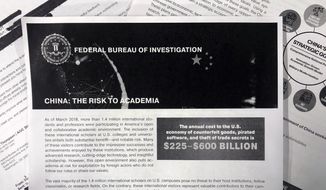 This Oct. 4, 2019 photo shows a copy of an FBI pamphlet and related emails. The FBI’s outreach to American colleges and universities about the threat of economic espionage includes this pamphlet that warns specifically about efforts by China to steal academic research. (AP Photo)