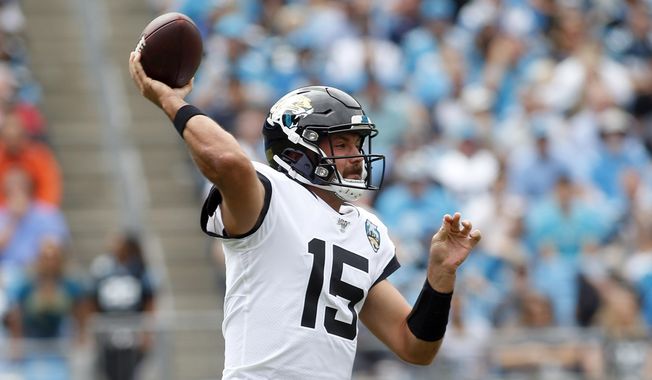 Jacksonville Jaguars quarterback Gardner Minshew (15) passes against the Carolina Panthers during the first half of an NFL football game in Charlotte, N.C., Sunday, Oct. 6, 2019. (AP Photo/Brian Blanco)