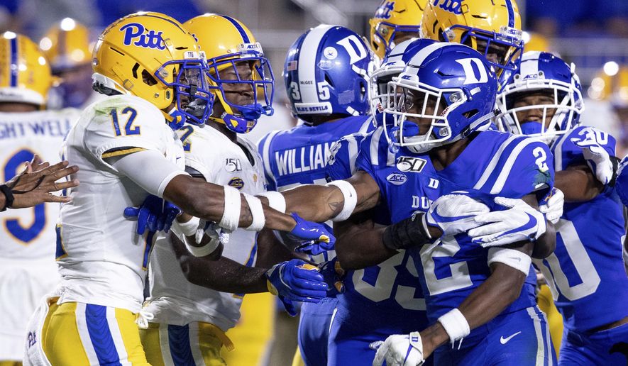 Pittsburgh's Paris Ford (12) and Duke's Javon Jackson (2) scuffle after a play during an NCAA college football game in Durham, N.C., Saturday, Oct. 5, 2019. (AP Photo/Ben McKeown)