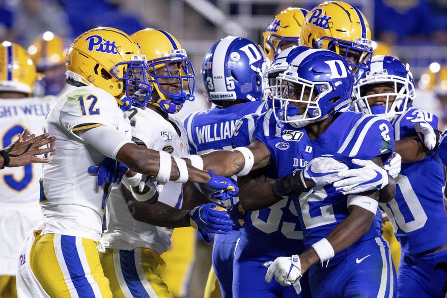Pittsburgh's Paris Ford (12) and Duke's Javon Jackson (2) scuffle after a play during an NCAA college football game in Durham, N.C., Saturday, Oct. 5, 2019. (AP Photo/Ben McKeown)