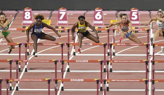 Luca Kozak, of Hungary, Nia Ali, of the United States, left, Danielle Williams, of Jamaica, Nadine Visser, of the Netherlands, and Cindy Roleder, of Germany, from left, compete in the women&#39;s 100 meter hurdles semifinal at the World Athletics Championships in Doha, Qatar, Sunday, Oct. 6, 2019. (AP Photo/Martin Meissner)