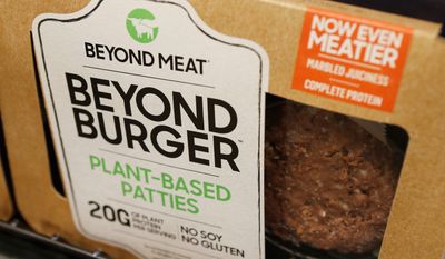 In this June 27, 2019, file photo a meatless burger patty called Beyond Burger made by Beyond Meat is displayed at a grocery store in Richmond, Va. Shares of Beyond Meat are tumbling in Thursday, Aug. 1, premarket trading after the plant-based meat maker priced a secondary stock offering at more than six times its initial public offering opening price. (AP Photo/Steve Helber, File)