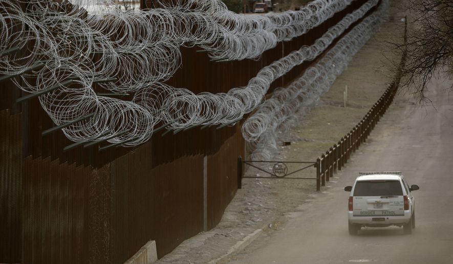 In this March 2, 2019 file photo a Customs and Border Control agent patrols on the US side of a razor-wire-covered border wall that separates Nogales, Mexico from Nogales, Ariz. A U.S. Border Patrol agent has died after being found unresponsive while on patrol near the Arizona border, but authorities say there&#x27;s no evidence of foul play. The agency&#x27;s Tucson sector says in a Monday, Oct. 7, 2019, statement that agents on Sunday found 44-year-old Robert Hotten unresponsive near Mount Washington south of Patagonia in southeastern Arizona. He was patrolling alone, which is customary. (AP Photo/Charlie Riedel,File)