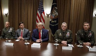 President Donald Trump, joined by from left, Gen. David Berger, Defense Secretary Mark Esper, and Chairman of the Joint Chiefs of Staff Gen. Mark Milley, and Gen. Joseph M. Martin, pauses as he speaks to media during a briefing with senior military leaders in the Cabinet Room at the White House in Washington, Monday, Oct. 7, 2019. (AP Photo/Carolyn Kaster)