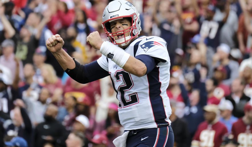 New England Patriots quarterback Tom Brady (12) reacts to a touchdown against the Washington Redskins during the second half of an NFL football game, Sunday, Oct. 6, 2019, in Washington. (AP Photo/Mark Tenally)