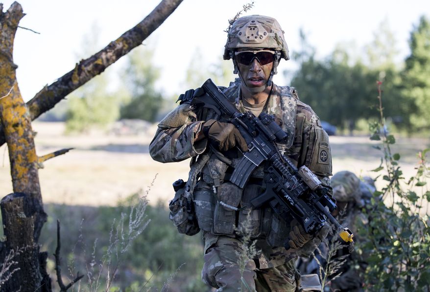 In this Saturday, June 9, 2018, file photo, a U.S. paratrooper of the 82nd Airborne Division from Fort Bragg in North Carolina takes part in a military exercise "Saber Strike 2018" at the Gaiziunai Training Area some 130 kms (80 miles) west of the capital Vilnius, Lithuania. (AP Photo/Mindaugas Kulbis) ** FILE **