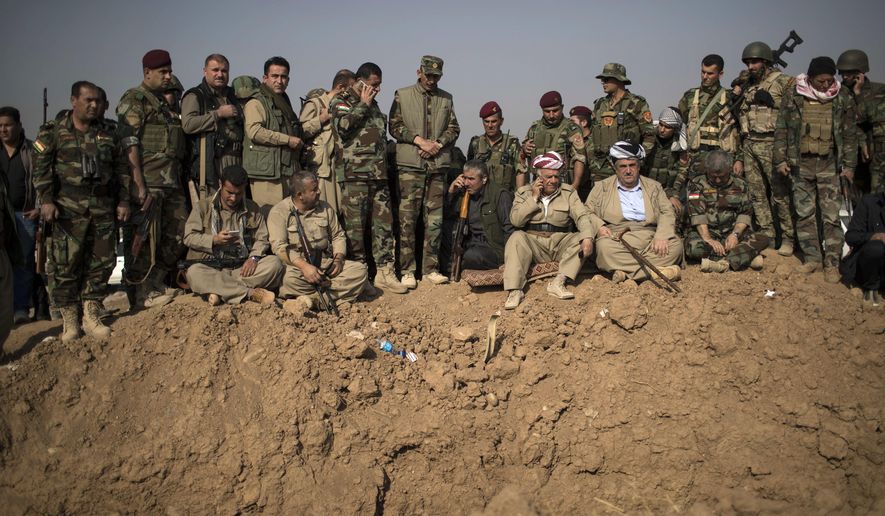 Kurdish Peshmerga fighters and commanders overlook Islamic State group positions during heavy fighting in Bashiqa, east of Mosul, Iraq.  (AP Photo/Felipe Dana, File)