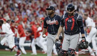 Atlanta Braves&#39; Julio Teheran and catcher Brian McCann walk to the dugout after St. Louis Cardinals&#39; Yadier Molina hit a sacrifice fly to score Kolten Wong for the winning run during the 10th inning in Game 4 of a baseball National League Division Series, Monday, Oct. 7, 2019, in St. Louis. (AP Photo, Charlie Riedel)