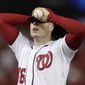 Washington Nationals starting pitcher Patrick Corbin covers his face after allowing a two-run double to Los Angeles Dodgers Russell Martin during the sixth inning in Game 3 of a baseball National League Division Series on Sunday, Oct. 6, 2019, in Washington. The Dodgers won 10-4. (AP Photo/Julio Cortez)
