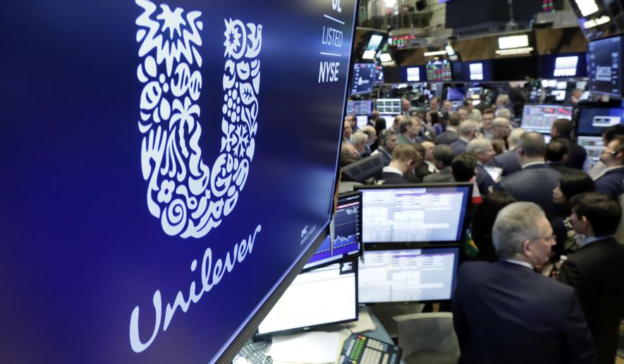 FILE - In this Thursday, March 15, 2018 file photo, the logo for Unilever appears above a trading post on the floor of the New York Stock Exchange. Consumer products giant Unilever, whose brands include Dove soaps and Lipton teas, said on Monday Oct. 7, 2019, they are pledging to halve its use of non-recycled plastics by 2025. (AP Photo/Richard Drew, File)