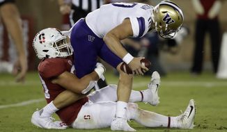 Washington quarterback Jacob Eason is sacked by Stanford&#x27;s Scooter Harrington, left, in the second half of an NCAA college football game Saturday, Oct. 5, 2019, in Stanford, Calif. (AP Photo/Ben Margot)