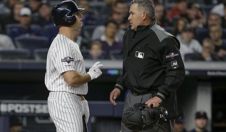 New York Yankees' Brett Gardner, left, talks with home plate umpire Manny Gonzalez after striking out against the Minnesota Twins during the first inning of Game 1 of an American League Division Series baseball game, Friday, Oct. 4, 2019, in New York. (AP Photo/Seth Wenig)