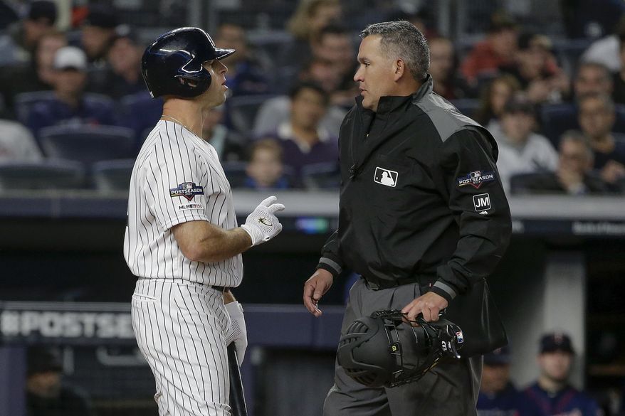 New York Yankees' Brett Gardner, left, talks with home plate umpire Manny Gonzalez after striking out against the Minnesota Twins during the first inning of Game 1 of an American League Division Series baseball game, Friday, Oct. 4, 2019, in New York. (AP Photo/Seth Wenig)