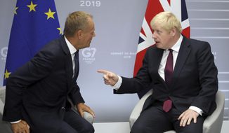 File - In this Sunday, Aug. 25, 2019 file photo, Britain&#39;s Prime Minister Boris Johnson, right, and President of the European Council Donald Tusk chat before a meeting on the side of the G-7 summit in Biarritz, France. With negotiations on the UK&#39;s departure terms from the EU hanging precariously in the balance at a time when silence seemed golden, both sides broke the spell Tuesday, Oct. 8, 2019 when Tusk directly addressed Johnson on Twitter and gave him his fill about the fast crumbling Brexit negotiations. (AP Photo/Markus Schreiber, File)