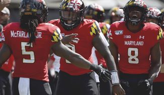 FILE - In this Sept. 7, 2019, file photo, Maryland Terrapins running back Anthony McFarland Jr. (5) celebrates with Tyrrell Pigrome (3) and Tayon Fleet-Davis (8) after scoring a touchdown against Syracuse during the first half of an NCAA college football game, in College Park, Md. Maryland&#39;s annual quarterback shuffle appears set to continue, as Josh Jackson&#39;s ankle injury sets the stage for Tyrrell Pigrome to get his first start of the season Saturday at Purdue. (AP Photo/Will Newton)