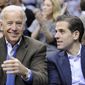 In this Jan. 30, 2010, photo, Vice President Joe Biden, left, with his son Hunter, right, at the Duke Georgetown NCAA college basketball game in Washington. (AP Photo/Nick Wass) ** FILE **