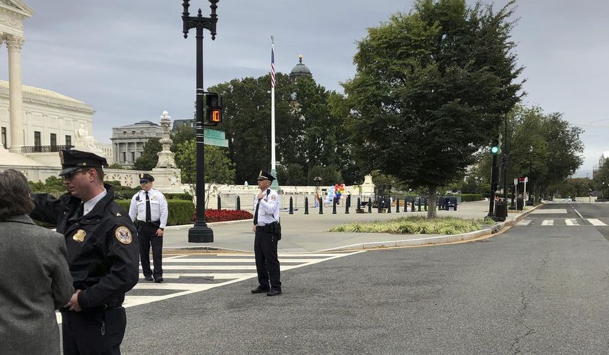 The streets outside the front of the Supreme Court are closed off for a suspicious package, Tuesday morning, Oct. 8, 2019 in Washington. (AP Photo/Mark Sherman)