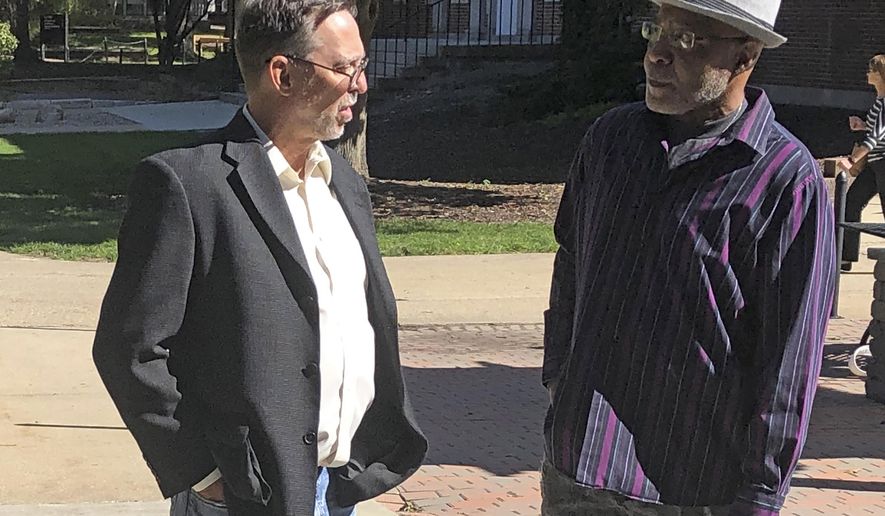 Terry Harrington, right, speaks with attorney Tom Frerichs on the Coe College campus in Cedar Rapids, Iowa, on Tuesday, Oct. 8, 2019. Harrington, who spent more than 25 years in an Iowa prison for a 1977 murder he did not commit, shared his experience with students on Tuesday, in his first public comments in years. (AP Photo/John Foley)