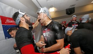 St. Louis Cardinals starting pitcher Jack Flaherty, right, celebrates with teammate Daniel Ponce de Leon after the Cardinals beat the Atlanta Braves 13-1 in Game 5 of their National League Division Series baseball game Wednesday, Oct. 9, 2019, in Atlanta. (AP Photo/John Bazemore)