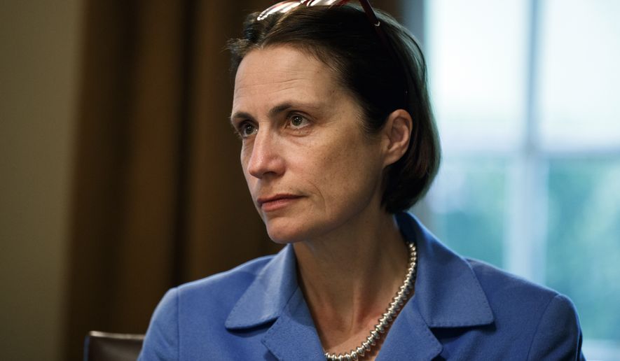 Fiona Hill, senior director for European and Russian Affairs on the National Security Council, listens as President Donald Trump speaks during a meeting NATO Secretary General Jens Stoltenberg in the Cabinet Room of the White House, Tuesday, April 2, 2019, in Washington. (AP Photo/Evan Vucci)