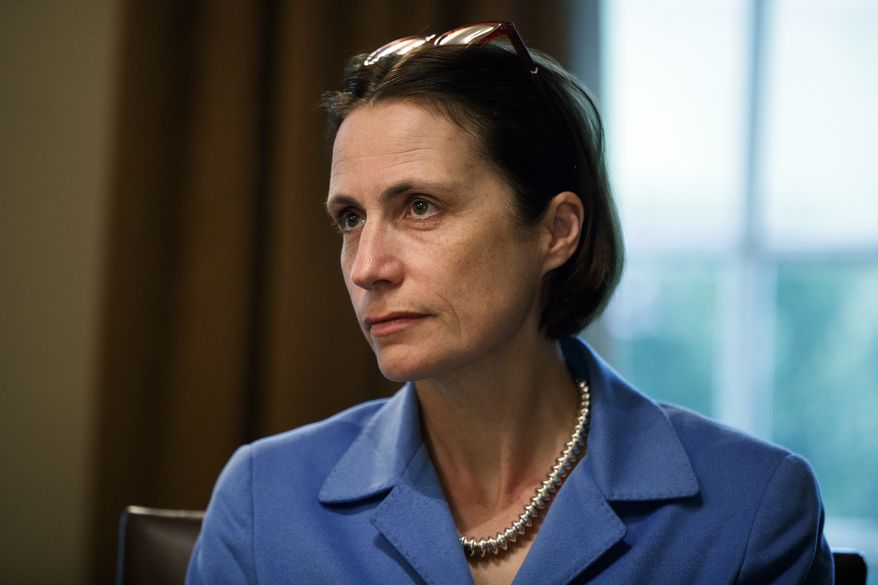 Fiona Hill, senior director for European and Russian Affairs on the National Security Council, listens as President Donald Trump speaks during a meeting NATO Secretary General Jens Stoltenberg in the Cabinet Room of the White House, Tuesday, April 2, 2019, in Washington. (AP Photo/Evan Vucci)