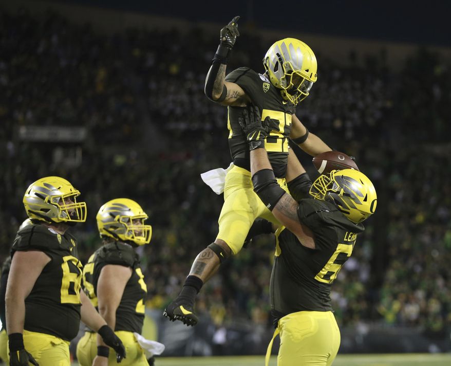 Oregon's Cyrus Habibi-Likio is hoisted in celebration by Shane Lemieux after scoring a touchdown against California during the third quarter of an NCAA college football game Saturday, Oct. 5, 2019, in Eugene, Ore. (AP Photo/Chris Pietsch)