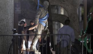 FILE - In this Aug. 21, 2017 file photo, a statue of Confederate Gen. Robert E. Lee is removed from the University of Texas campus, in Austin, Texas. Judges for the 5th U.S. Circuit Court of Appeals heard oral arguments Tuesday Oct. 8, 2019, in the latest effort to counter the University of Texas&#39; removal of several Confederate statues. In 2017, after violent white supremacist demonstrations in Charlottesville, Va., UT President Gregory L. Fenves authorized the removal of statues of Confederate figures — Robert E. Lee, Albert Sidney Johnston and John Reagan — along with Gov. James Stephen Hogg from the UT South Mall. (AP Photo/Eric Gay)