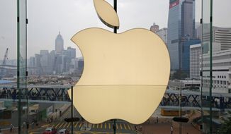 In this Sept. 24, 2011, photo, an Apple logo is displayed at the Apple store in the International Financial Center (IFC) shopping Mall, in Hong Kong. Apple became the latest company targeted for Chinese pressure over protests in Hong Kong when the ruling Communist Party&#x27;s main newspaper criticized the tech giant Wednesday for a smartphone app that allows activists to report police movements. (AP Photo/Kin Cheung)