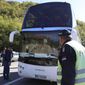 Serbian police officers guard a bus with Red Star players at the border crossing between Serbia and Kosovo, near the village of Rudnica, Serbia, Wednesday, Oct. 9, 2019. Kosovo authorities have banned a soccer match between Red Star Belgrade and a local Serb team and prevented their bus from crossing into the former Serbian province. (AP Photo/Bojan Slavkovic)