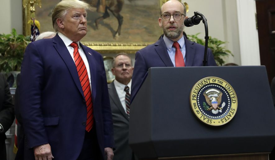 President Donald Trump listens as acting director of the Office of Management and Budget Russ Vought speaks during an event on "transparency in Federal guidance and enforcement" in the Roosevelt Room of the White House, Wednesday, Oct. 9, 2019, in Washington. (AP Photo/Evan Vucci)