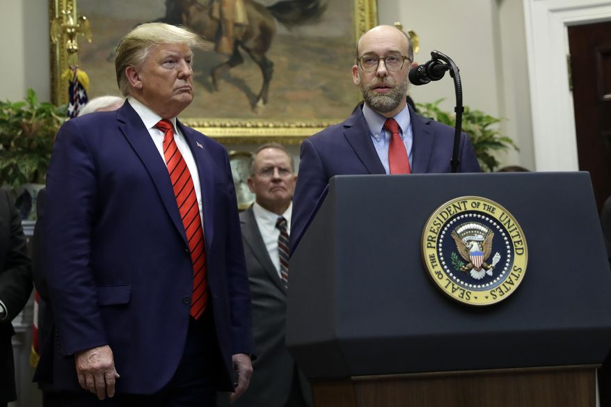 President Donald Trump listens as acting director of the Office of Management and Budget Russ Vought speaks during an event on "transparency in Federal guidance and enforcement" in the Roosevelt Room of the White House, Wednesday, Oct. 9, 2019, in Washington. (AP Photo/Evan Vucci)