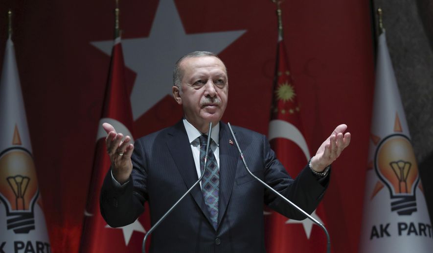 Turkey's President Recep Tayyip Erdogan speaks to his ruling party officials, in Ankara, Turkey, Thursday, Oct. 10, 2019. Erdogan says that there have been 109 "terrorists killed" — a reference to Syrian Kurdish fighters — since Ankara launched an offensive into Syria the previous day. Erdogan also warned the European Union not to call Ankara's incursion into Syria an 'invasion,' and renewed his threat of letting Syrian refugees flood Europe. (Turkish Presidency Press Service via AP, Pool)