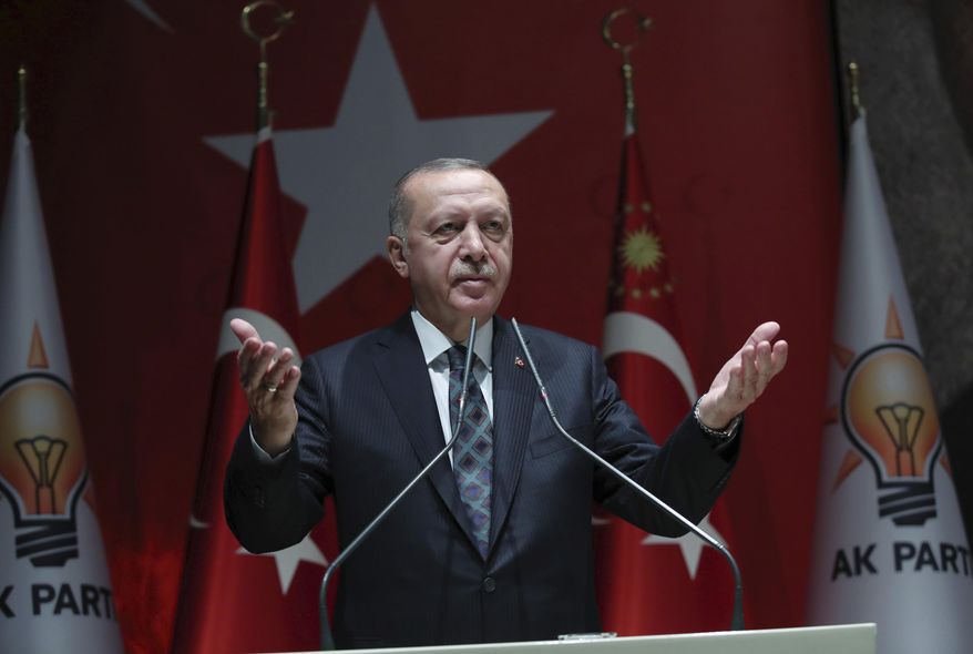 Turkey's President Recep Tayyip Erdogan speaks to his ruling party officials, in Ankara, Turkey, Thursday, Oct. 10, 2019. Erdogan says that there have been 109 "terrorists killed" — a reference to Syrian Kurdish fighters — since Ankara launched an offensive into Syria the previous day. Erdogan also warned the European Union not to call Ankara's incursion into Syria an 'invasion,' and renewed his threat of letting Syrian refugees flood Europe. (Turkish Presidency Press Service via AP, Pool)