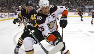 Anaheim Ducks&#39; Ryan Getzlaf (15) goes after the puck in the corner with Pittsburgh Penguins&#39; Sam Lafferty (37) during the second period of an NHL hockey game in Pittsburgh, Thursday, Oct. 10, 2019. (AP Photo/Gene J. Puskar)