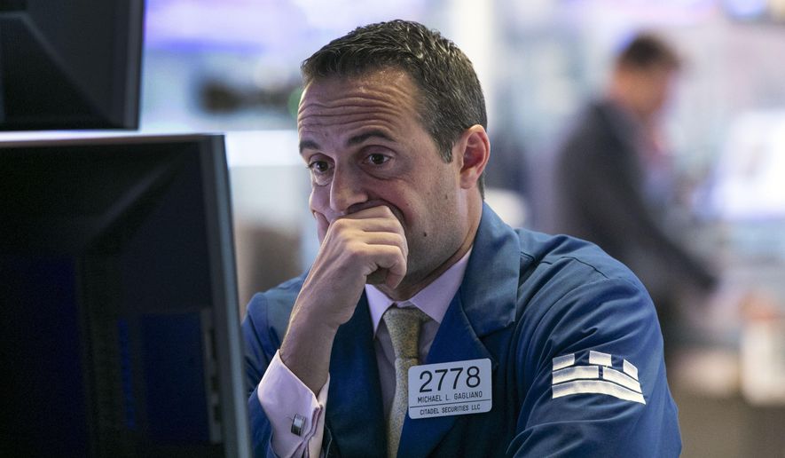 FILE - In this Oct. 2, 2019, file photo specialist Michael Gagliano works at his post on the floor of the New York Stock Exchange. The U.S. stock market opens at 9:30 a.m. EDT on Thursday, Oct. 10. (AP Photo/Richard Drew)